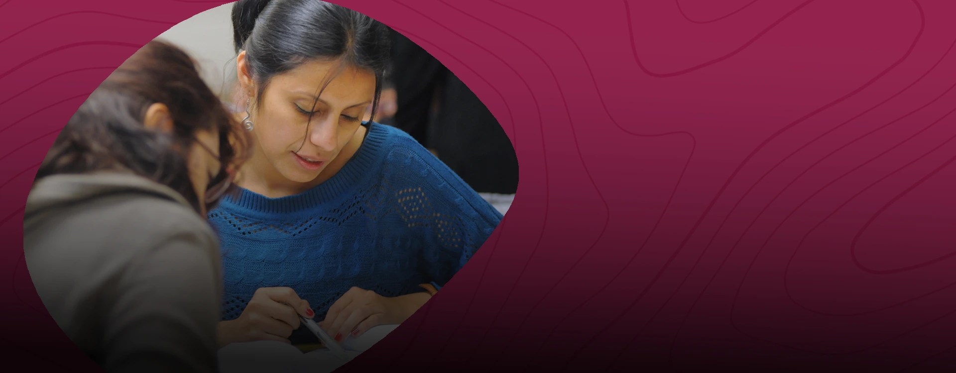 Two women reviewing a book together — NMSU Global Campus