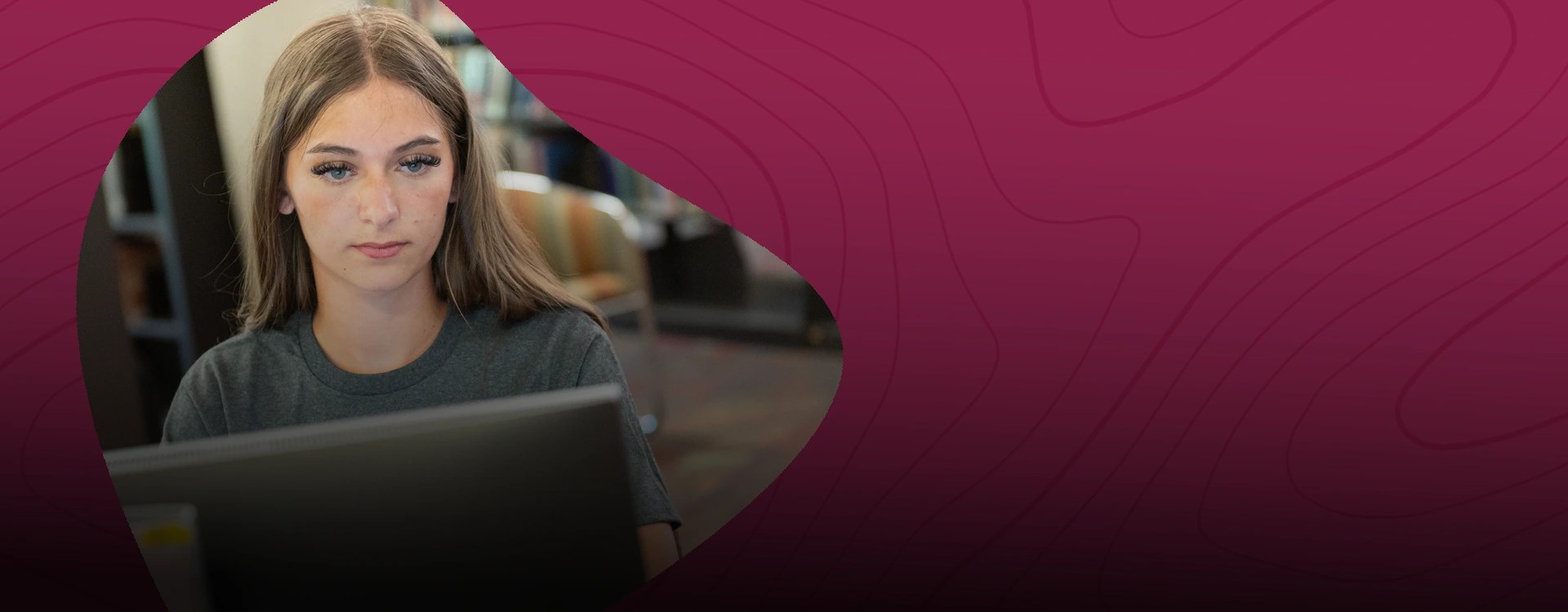 A criminal justice student does online coursework on her laptop at New Mexico State University Global Campus