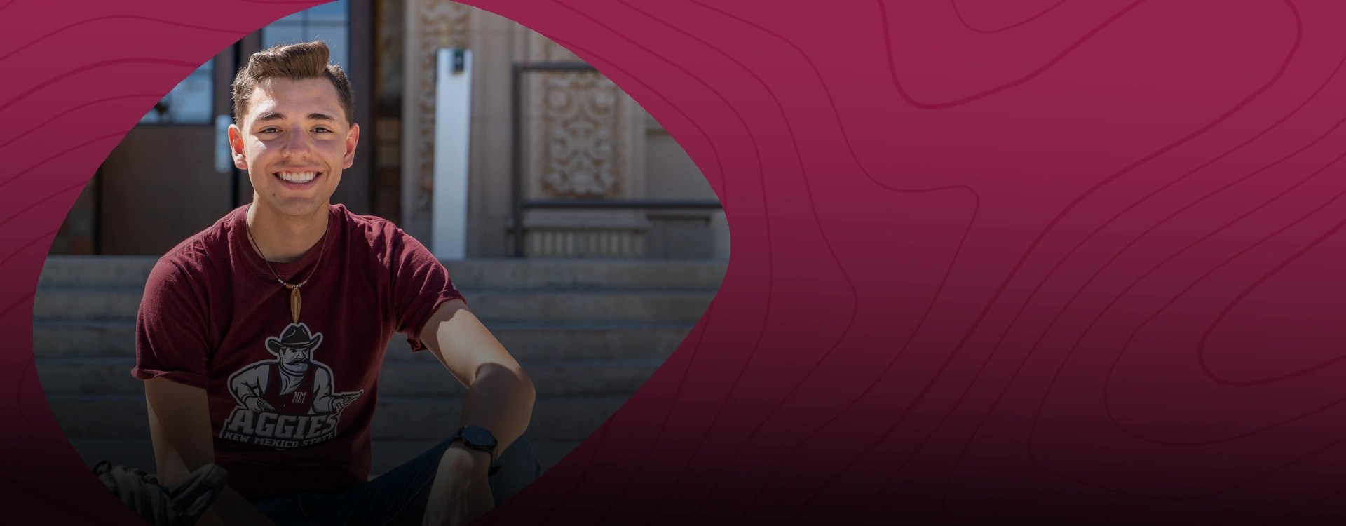 A smiling college student at New Mexico State University Global Campus poses on steps