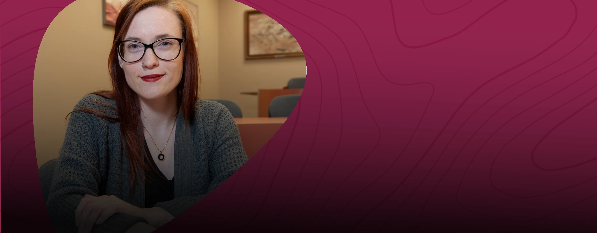 Smiling woman wearing glasses in an office — NMSU Global Campus