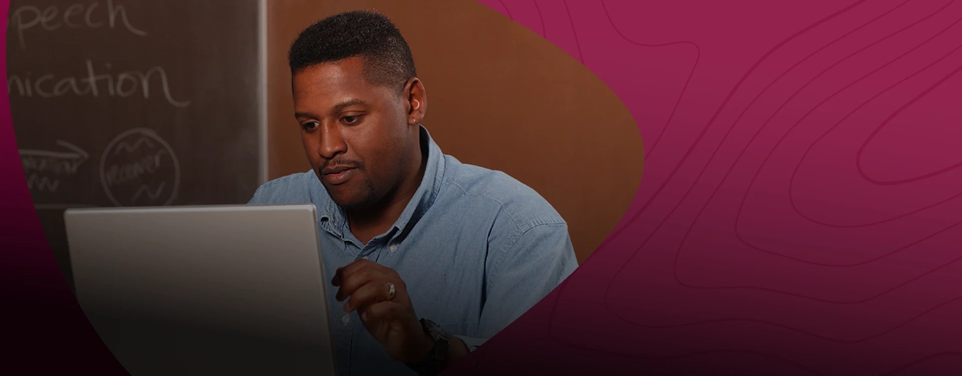 A man works on a laptop — NMSU Global Campus